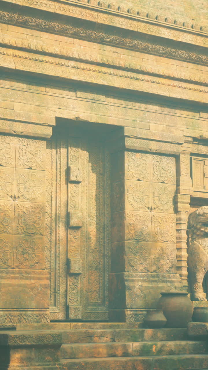 Ancient stone temple with lion statues surrounded by lush greenery