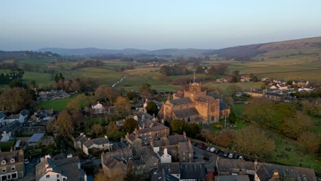 Aerial-footage-of-the-Medieval-village-of-Cartmel-in-the-English-Lake-District-it-has-a-rich-heritage,-and-varied-list-of-activities-for-visitors-and-tourists