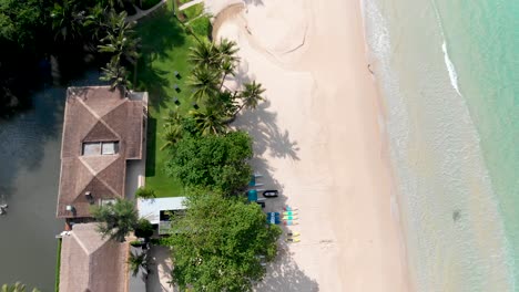 Overhead-aerial-drone-shot-of-the-different-resorts-and-hotel-accommodations-at-Pansea-Beach-in-Phuket,-Thailand