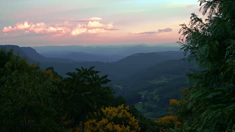 wonderful and intensive sunset of bold colors, over a misty and foggy valley, distant mountains