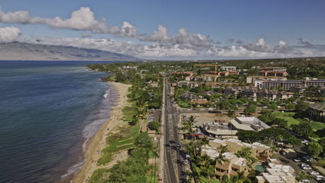 kihei maui hawaii aerial v9 low drone flyover along the coastline of kamaole beach park capturing town center of the island and mountain landscape views - shot with mavic 3 cine - december 2022