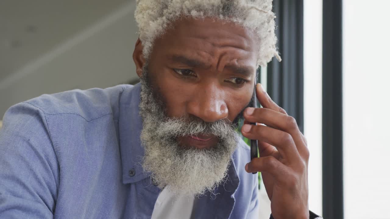 Video of african american senior man using smartphone