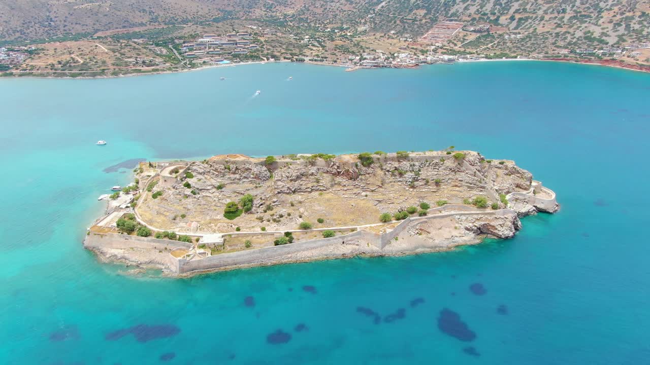 Aerial of a small island surrounded by turquoise waters in Spinalonga peninsula, Crete