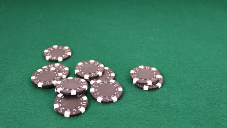 poker chips dropping onto a green felt table