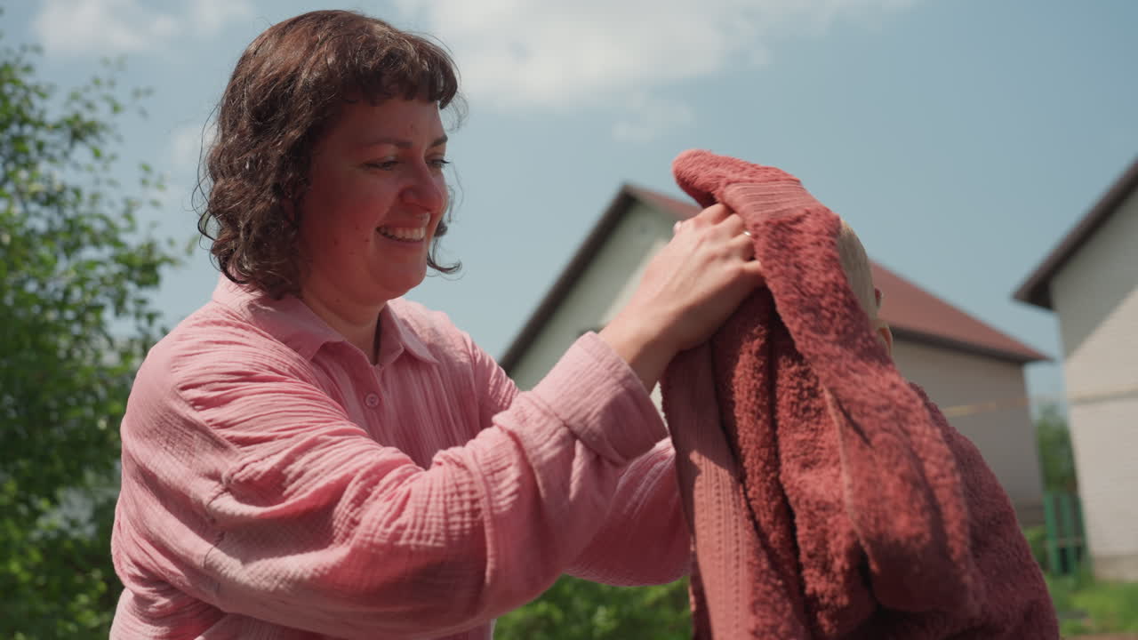 Child Bath Scene, Mother Lovingly Bathes Toddler Today, Warm Sunlight Shines As Mother Cares For Little One, Tender Mother Gently Cleanses Her Young Child Under Glowing Sunlight And Affection