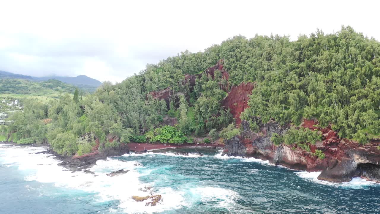 Aerial fly in of red sand beach in Maui, Hawaii