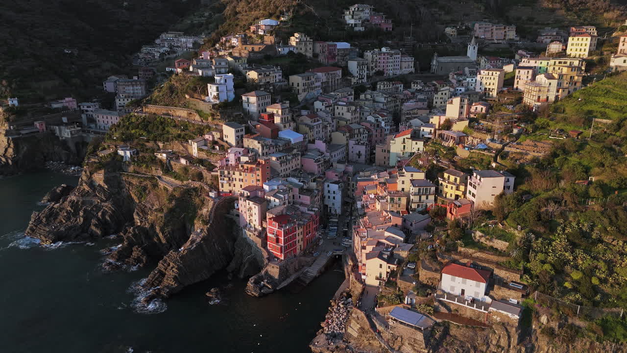Colorful seaside village in Riomaggiore, Cinque Terre with houses clinging to cliffs