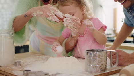 handheld view of little girl making cookies with parents