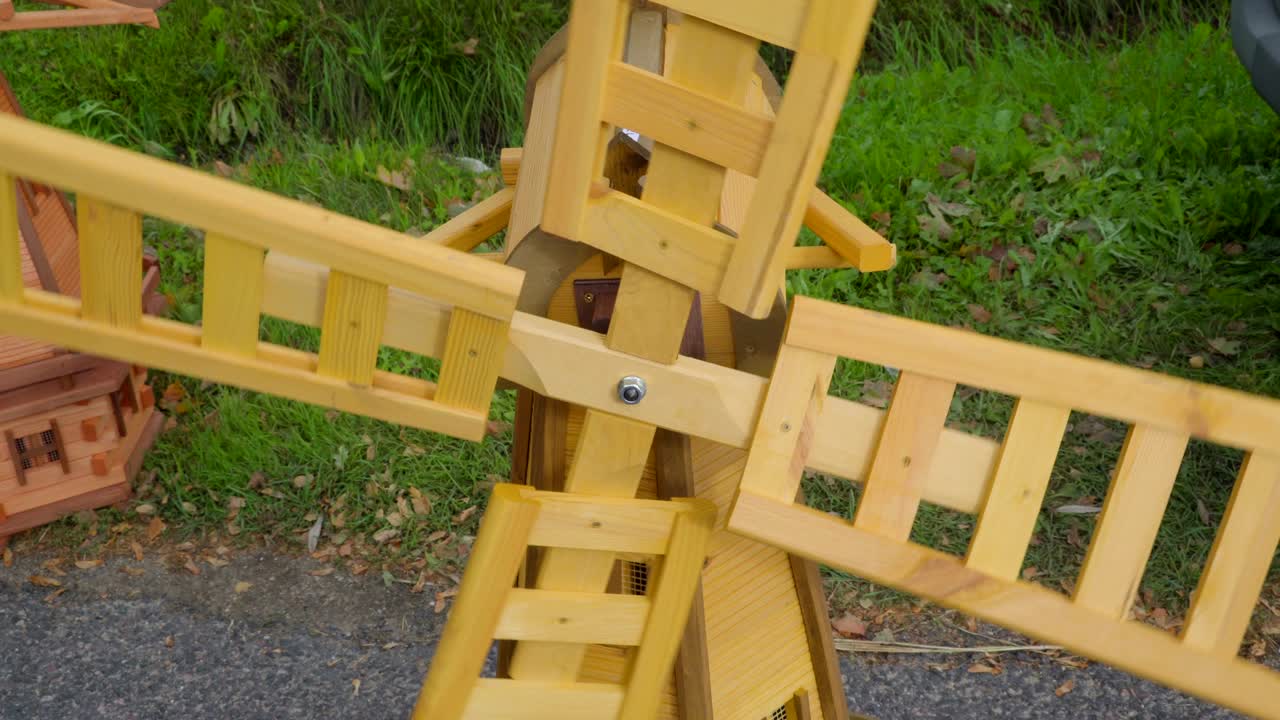 Closer look of the wooden toy windmill outside