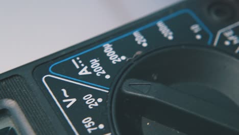 multimeter with connected probes on clean white background