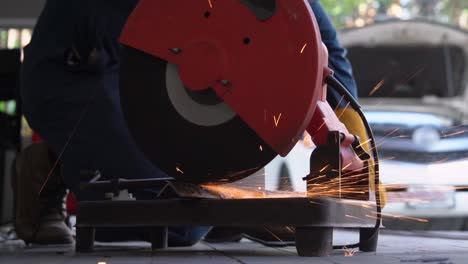 Professional-mechanic-is-cutting-steel-metal.