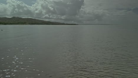 Fast-low-aerial-over-sea-surface-by-islands-in-cloudy-Philippines