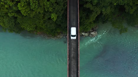 Top-down-view-as-car-crosses-small-bridge-over-River-in-Shikoku-Japan