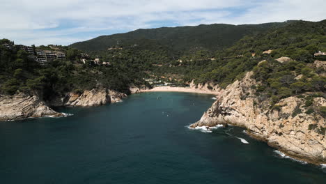 Wide-Sliding-Drone-Shot-of-Spanish-Beach-in-Giverola,-Costa-Brava