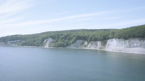 Drone-Aerial-Shot-of-the-chalk-cliffs-on-Ruegen-Rügen-in-Germany-in-beautiful-light-with-green-and-blue-seawater,-Europe