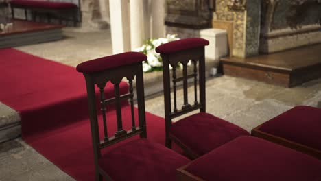 empty chairs await the wedding couple in a church