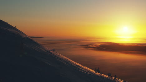 a free skier descends the slope towards an incredible sunrise