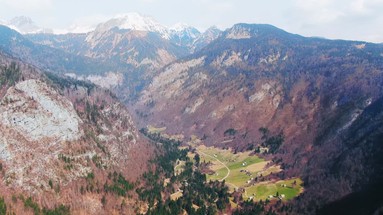 Spectacular aerial shot of small villages in the middle of Julian Alps in Slovenia. Jib up