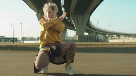 woman crouching on street and dancing