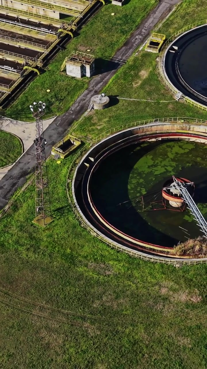 A water treatment facility is shown from above with large tanks and pipes