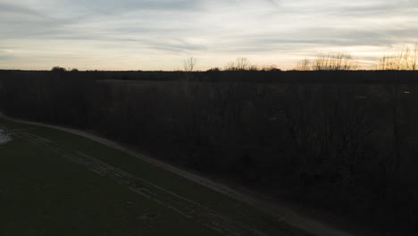 Sunset-over-Loosahatchie-River-in-Tennessee,-silhouette-trees,-serene-dusk-setting,-aerial-view