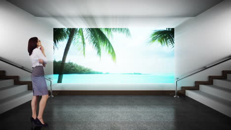 businesswoman looking at screen showing beach paradise