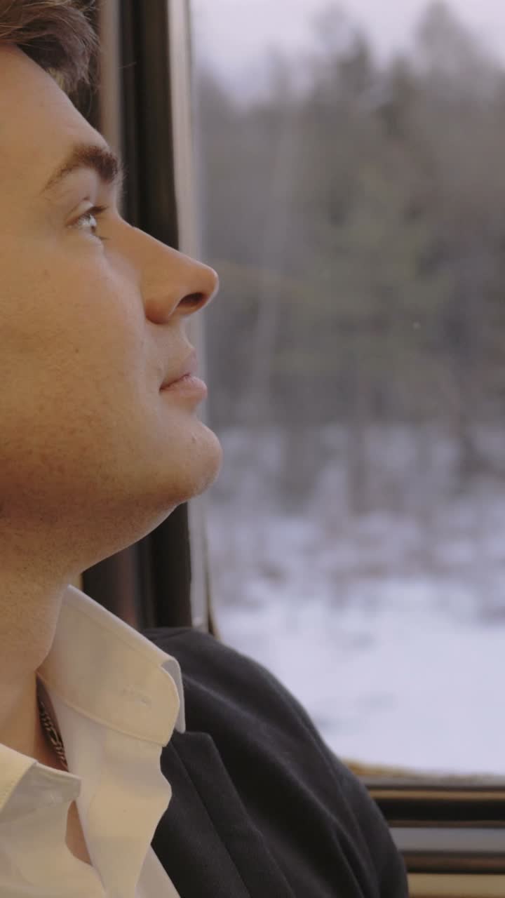 Man looking out train window