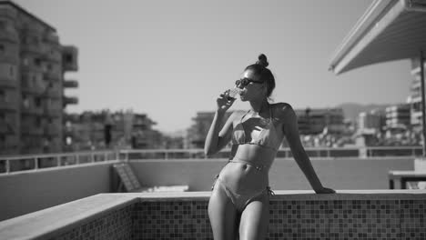 woman in bikini on rooftop pool