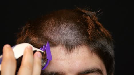 Close-up-of-man-getting-buzzcut-at-salon