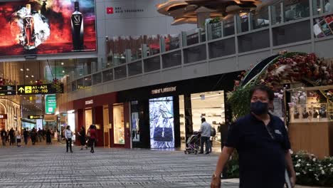 individuals walking in a busy shopping center