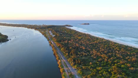 Aerial-View-Of-Cars-Driving-On-Fingal-Road-At-Fingal-Head---Tweed-River,-Fingal-Headland,-And-Cook-Island-At-Sunset-In-NSW,-Australia