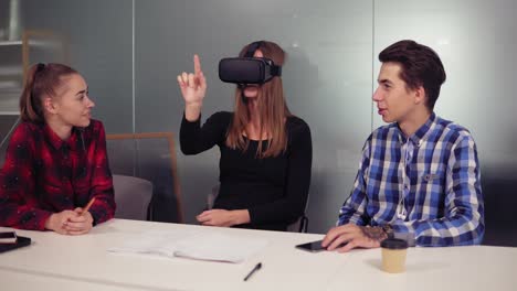 creative computer science students in modern office wearing vr headset and using vr application. futurism and innovation concept. trendy designers working in the office