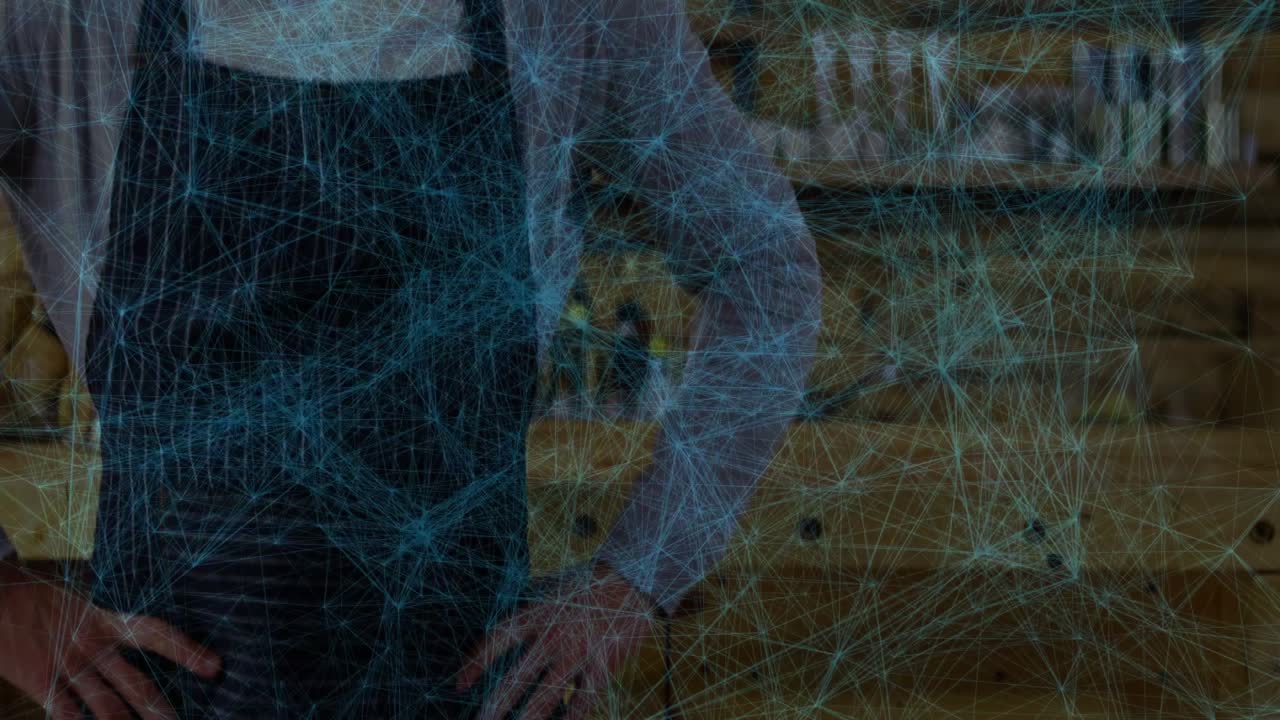 Mid-adult man preparing coffee in cafe, showing glowing technology network nodes connecting shelves
