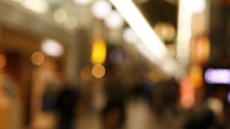 out-of-focus scenes of a busy shopping mall