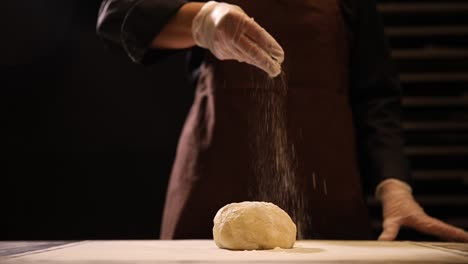 chef preparing dough with flour