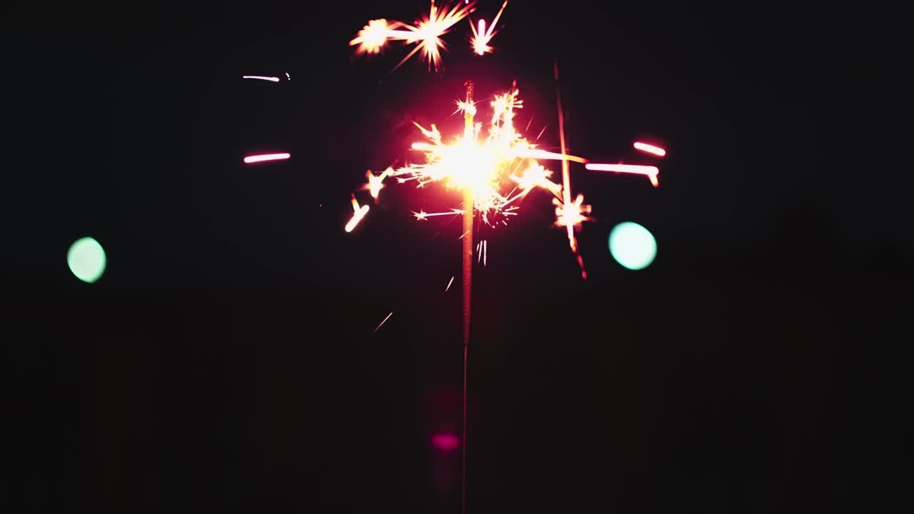 Fireworks background, abstract blur of real golden shining fireworks at the night sky, concept of new year's eve fireworks celebration.