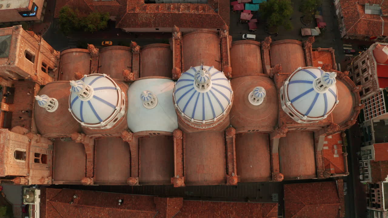 Stunning panoramic view of the historic center of Cuenca, Ecuador, with a focus on the majestic blue domes of the Cathedral of the Immaculate Conception.