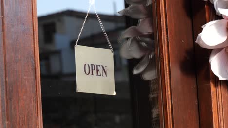 open sign on a wooden shop door