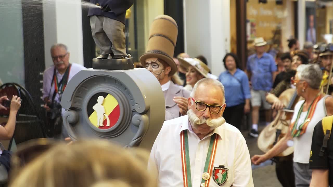 People dressed to change the outfit of "manneke pis" in city center of brussels.