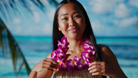 young woman in flower lei on a tropical beach