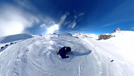 young man skiing energetically down piste with blue skies