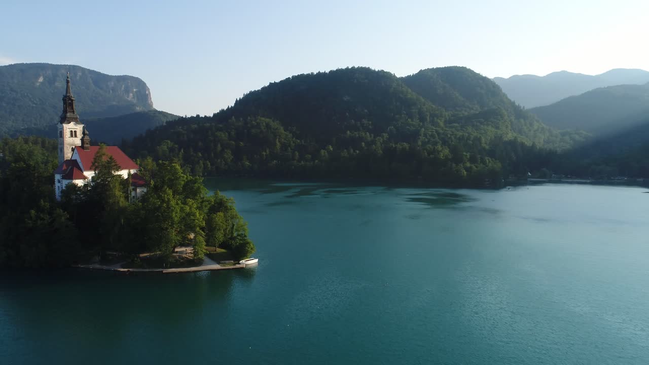 Aerial Drone Above Tiny Church on Lonely Island of Lake Bled Slovenian Summer Destination in Europe, Idyllic Unpolluted Water, Assumption of Mary