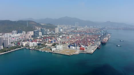 shenzhen commercial port terminal with docked ships and container yard, aerial view