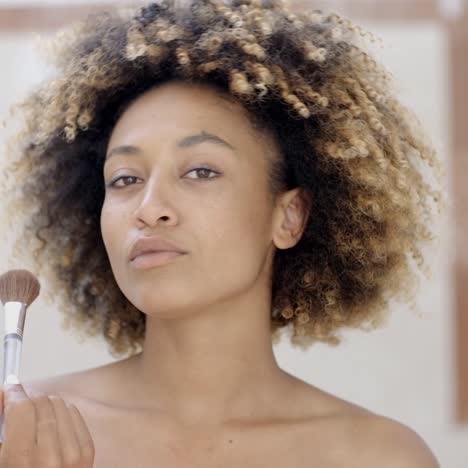 young woman putting make up