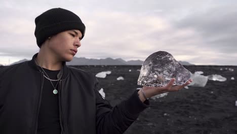 Man-in-outerwear-showing-piece-of-ice