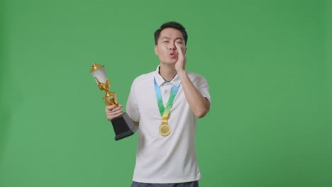 man celebrating a victory with trophy and medal