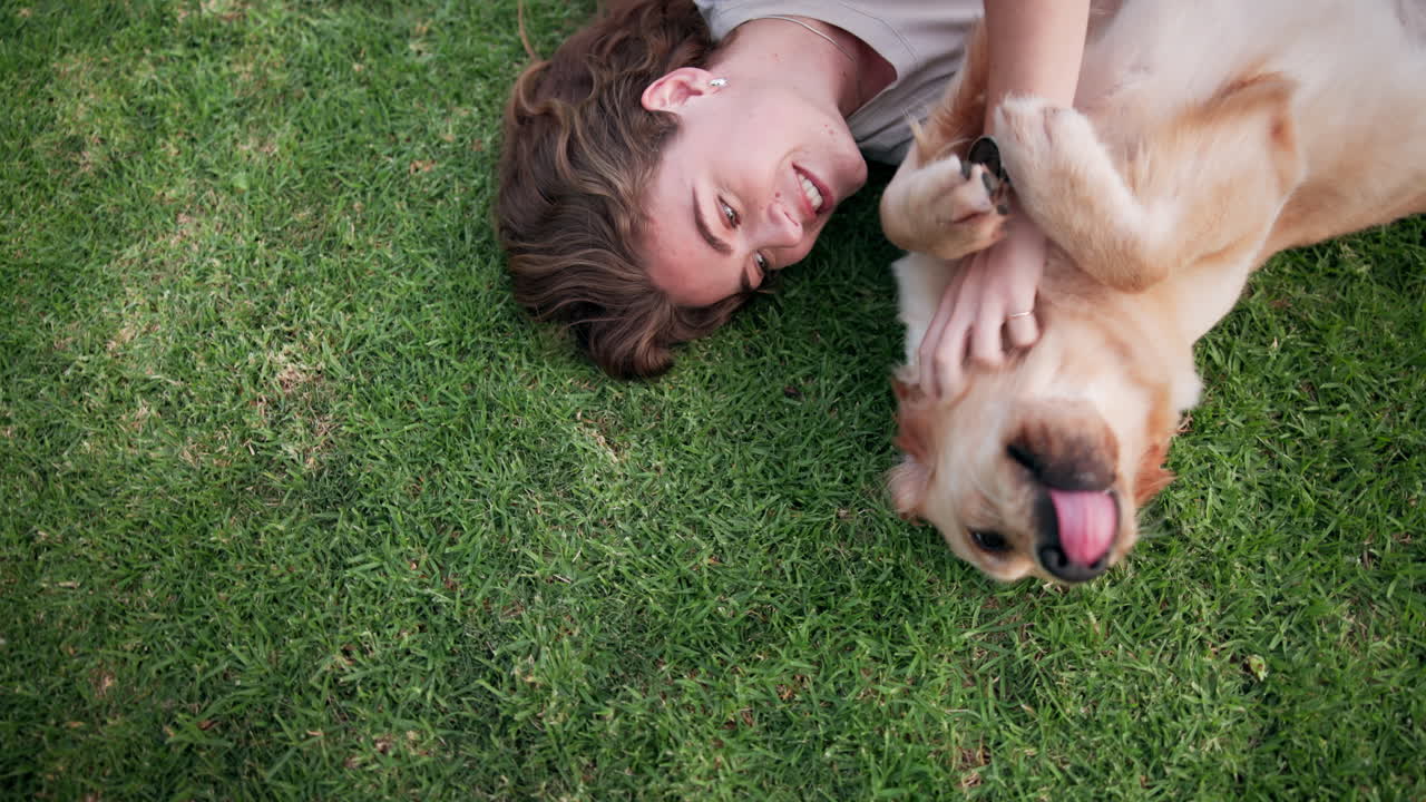 Woman and Golden Retriever Lying on Grass