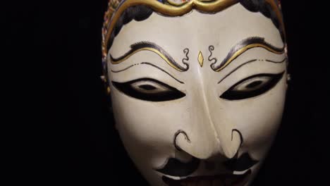 traditional mysterious topeng traditional mask of jogjakarta indonesia closeup, infinite black background