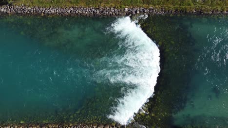 River-Lo-elva-coming-from-lovatnet-lake-in-Loen--Ascending-aerial-close-to-far-showing-steady-stream-of-cold-crispy-clean-glacier-water-flowing-towards-sea---Norway