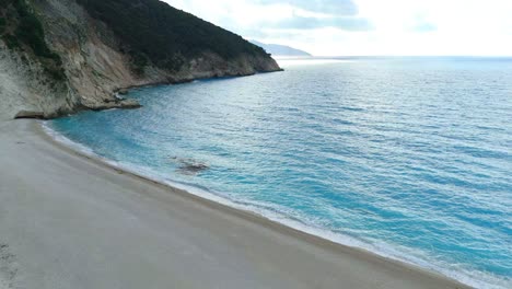 Aerial drone view of Myrtos Beach, Kefalonia, Greece with deep azure and turquoise waters, white rocky sandy shores under bright sunny skies in Europe’s stunning island paradis
